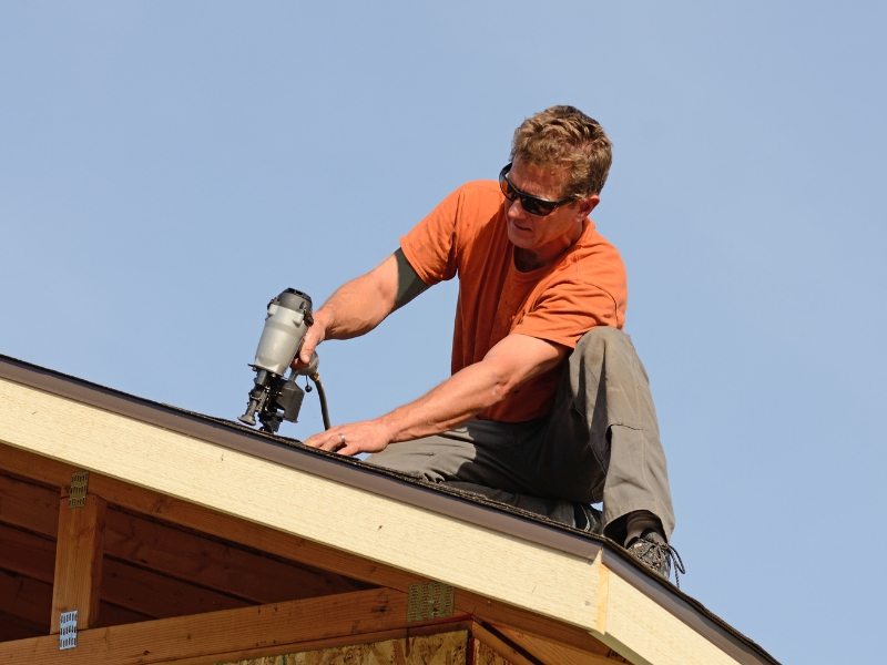 man installing roof